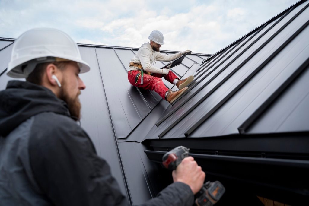 Roofer inspecting a metal roof seam